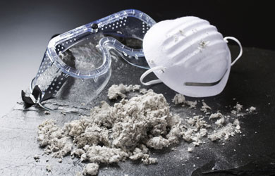 Goggles and a pile of material like lint or loose insulation