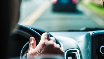 man driving along a road