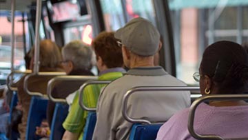 people riding on a public bus